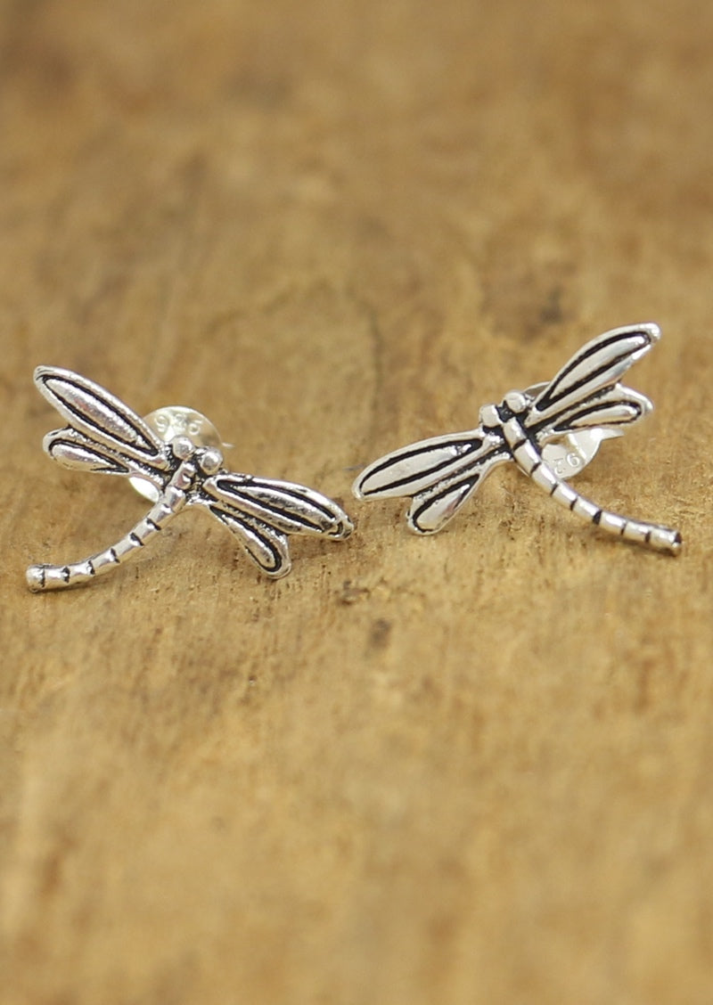 Large Dragonfly Silver stud earrings displayed on a wooden surface