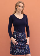 Model wears 100%cotton corduroy floral printed skirt with wide waistband, side zip, and pockets.