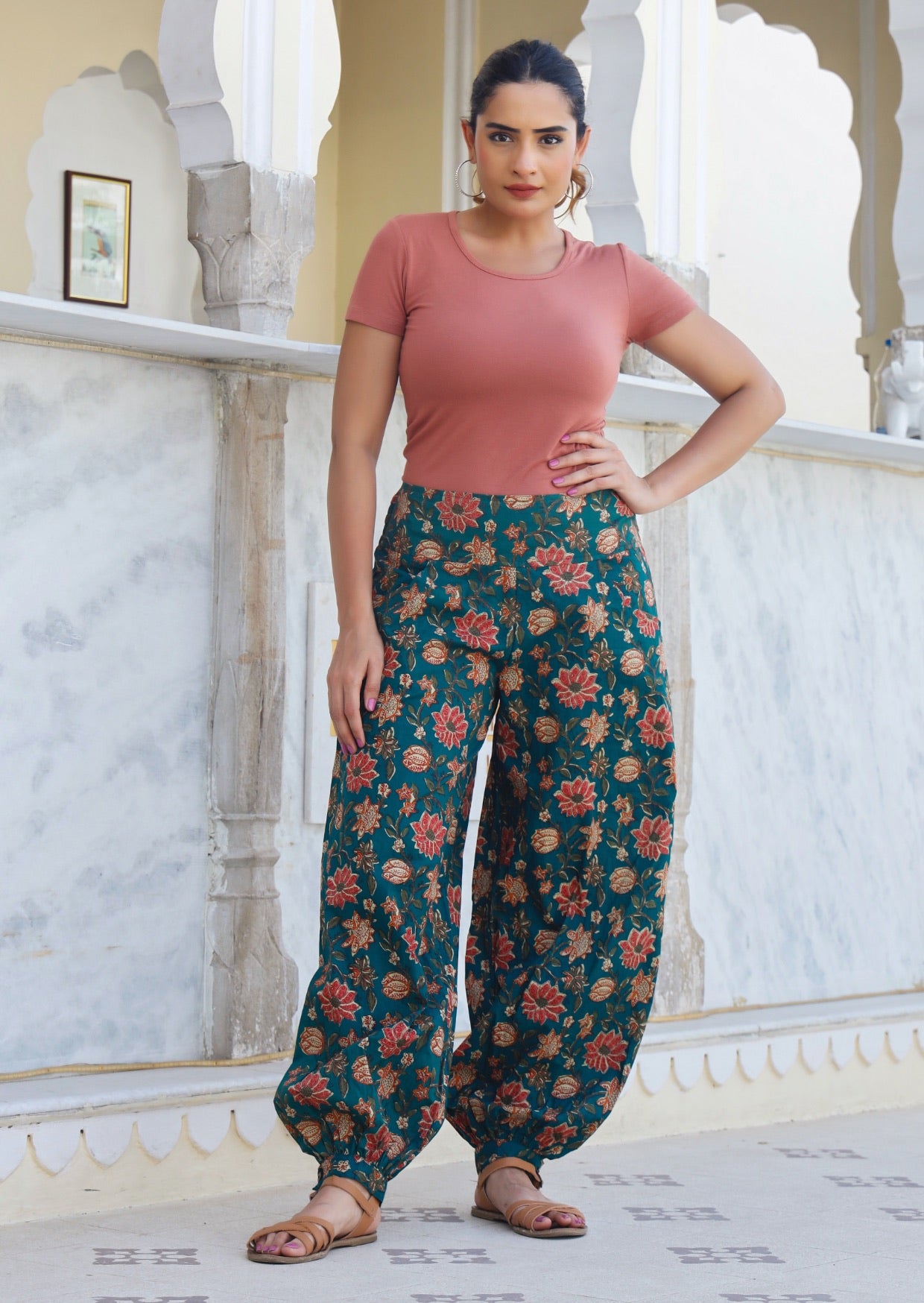 Model pairs floral printed green cotton harem pants with our scoop neck T shirt in dusty rose