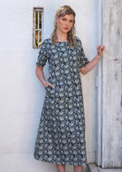 Blonde model is wearing a 100% cotton, loose fitting, short sleeve dress.