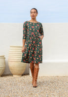 100% cotton knee length dress in deep green with empire waistline, pockets and 3/4 sleeves.