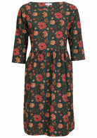 Deep green based, knee length cotton dress with wide round neckline and 3/4 sleeves.