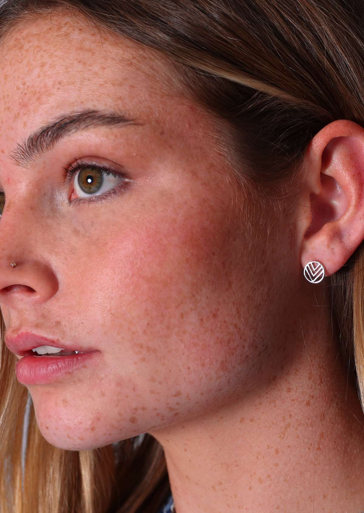 Model reveals Axis Silver Stud earring in left ear