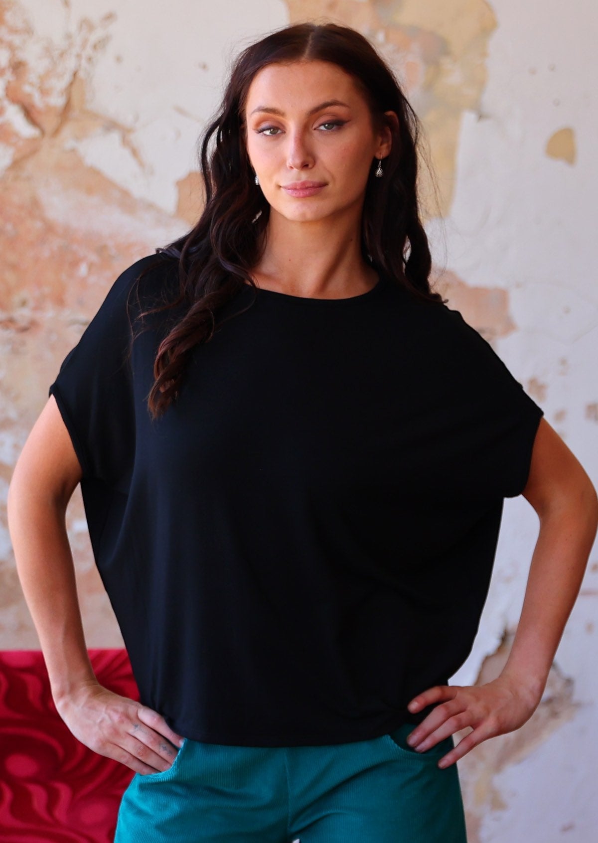 Woman wearing batwing t-shirt black loose fit