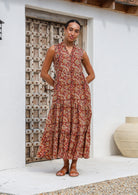 Woman wears 100% cotton dress with a buttoned bodice forms a V-neck with a mandarin collar.