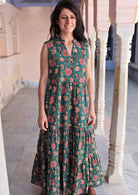 Model wears 3 tiered cotton maxi dress without sleeves and buttoned bodice.