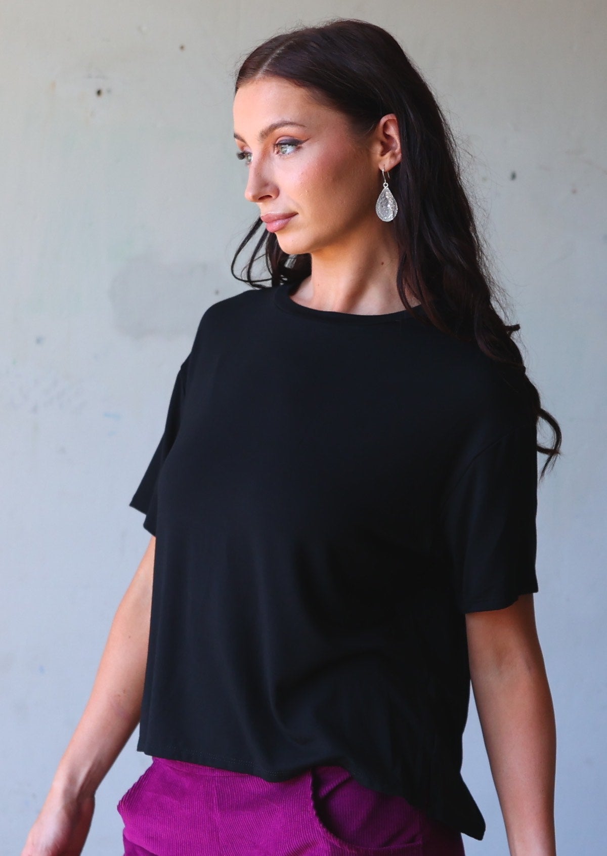 woman in loose fit black tee
