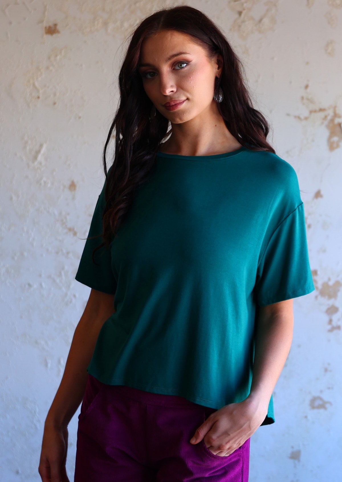 woman wearing loose fit teal blue t-shirt made of rayon