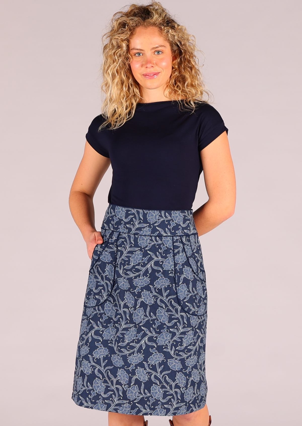 Model wearing Bridgette Skirt Neela navy cotton retro pencil skirt with one hand in pocket