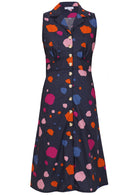 Sleeveless, button through dress with collar, gathers under the bust and pockets in navy based colorful spot print