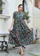 Model wears cotton relaxed fit midi length, tiered dress with T-shirt style sleeves, round neckline and pockets.