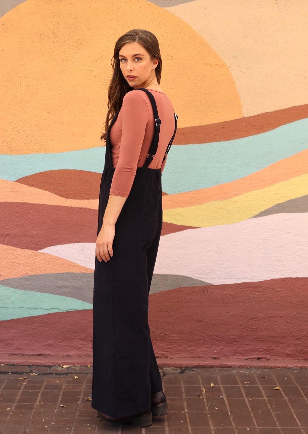 Side view of woman wearing cotton corduroy overalls