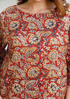Closeup image of floral print cotton top with stitch detailing across the bust.