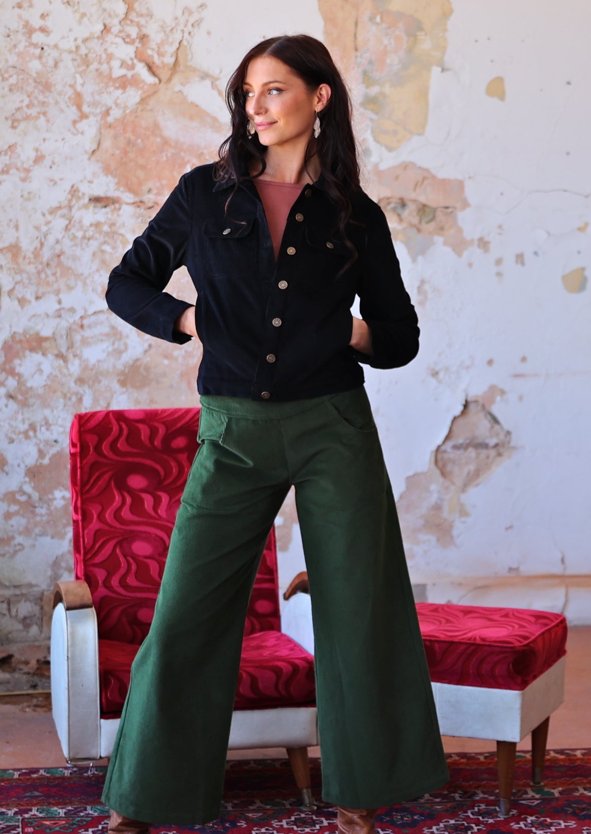 woman wearing black corduroy jacket and green corduroy pants