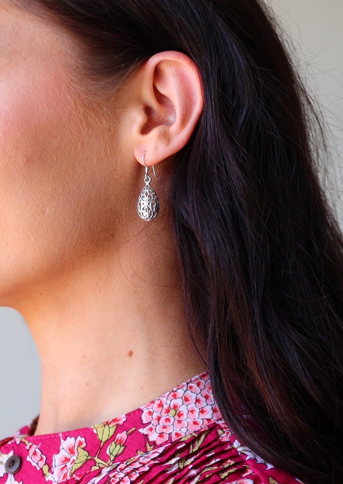 large silver drop earrings on woman with dark hair