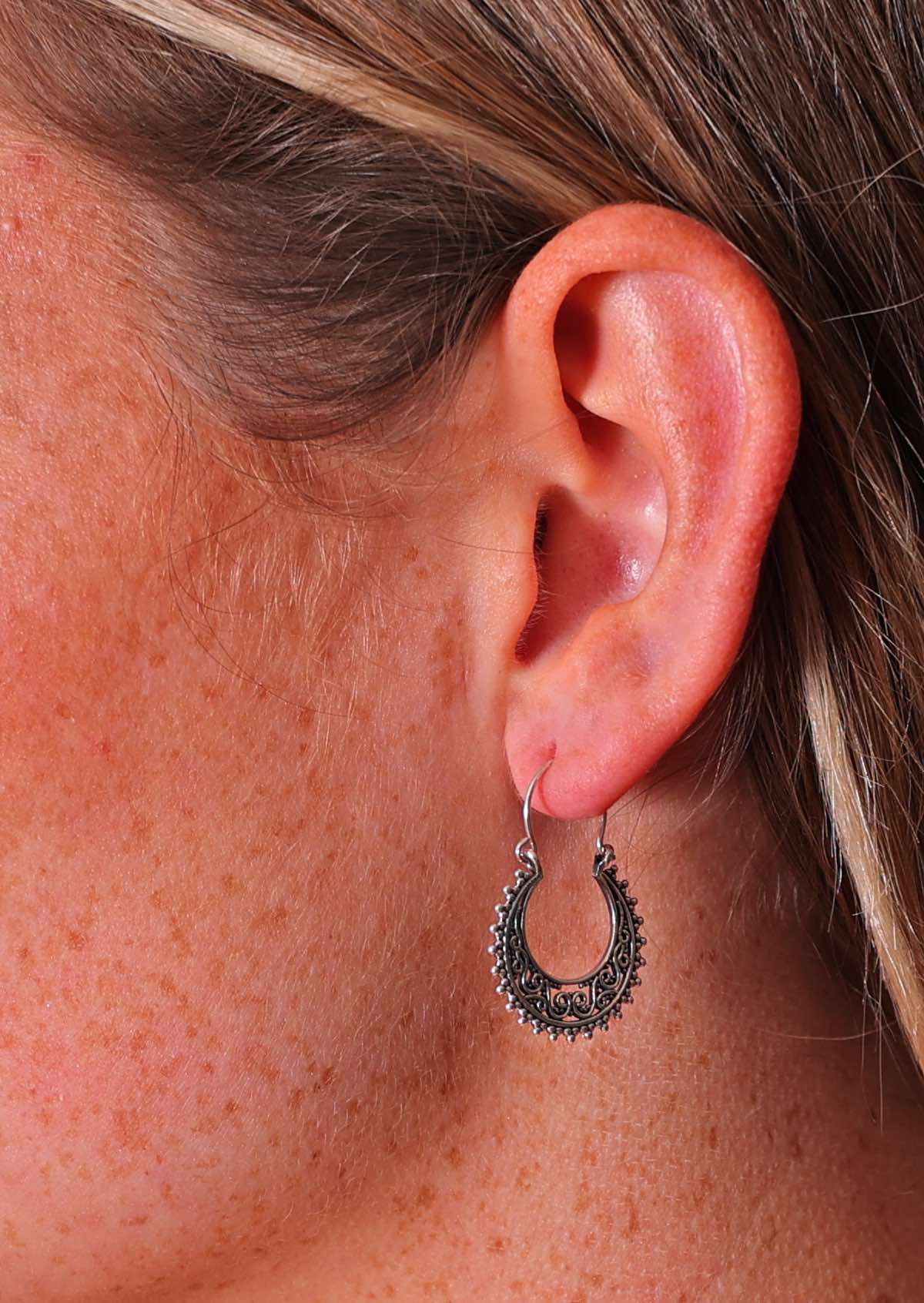 Close up of sterling silver filigree earring with wire hook