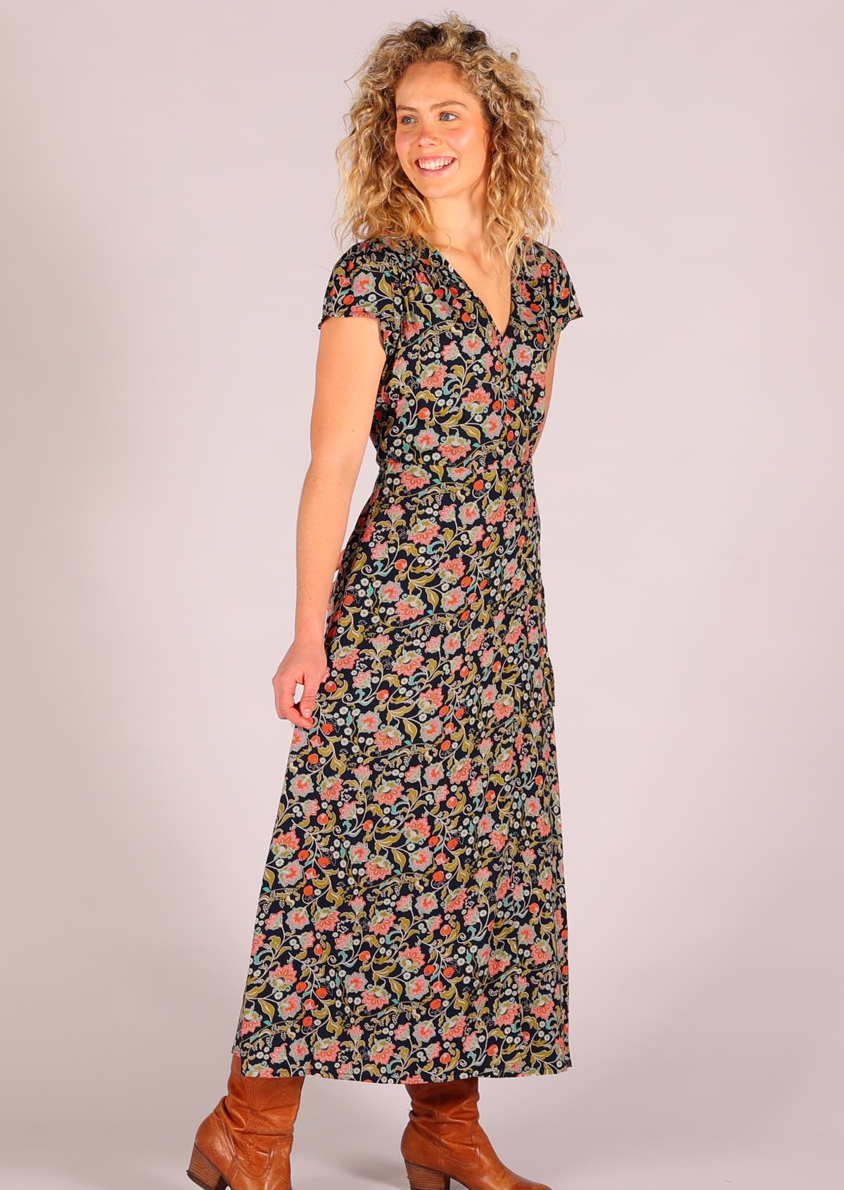 Model standing side on wearing navy floral rayon wrap maxi sundress