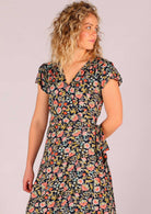 close up of Model wearing navy floral rayon wrap maxi sundress
