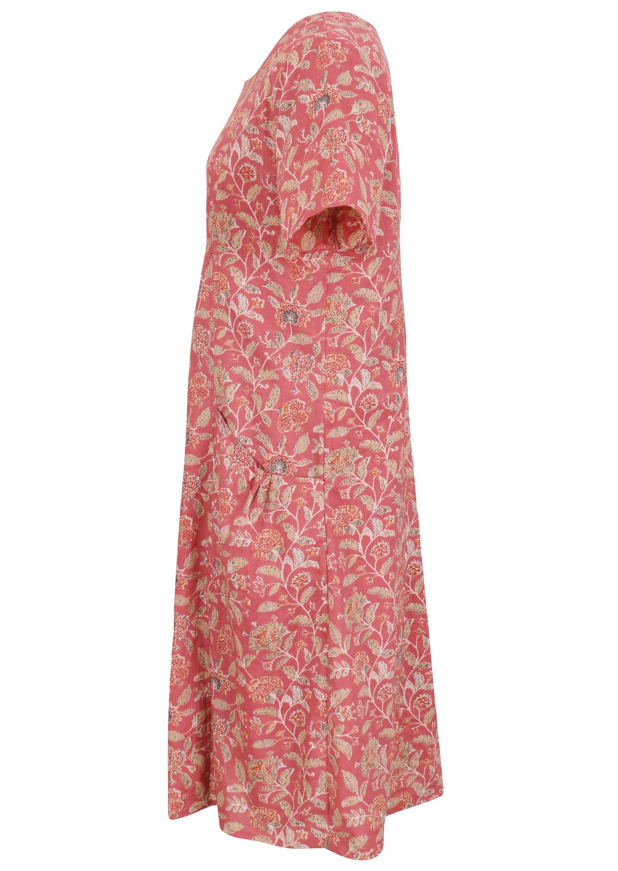 Side view of cotton dress with round neckline and short sleeves in rose pink based floral print.