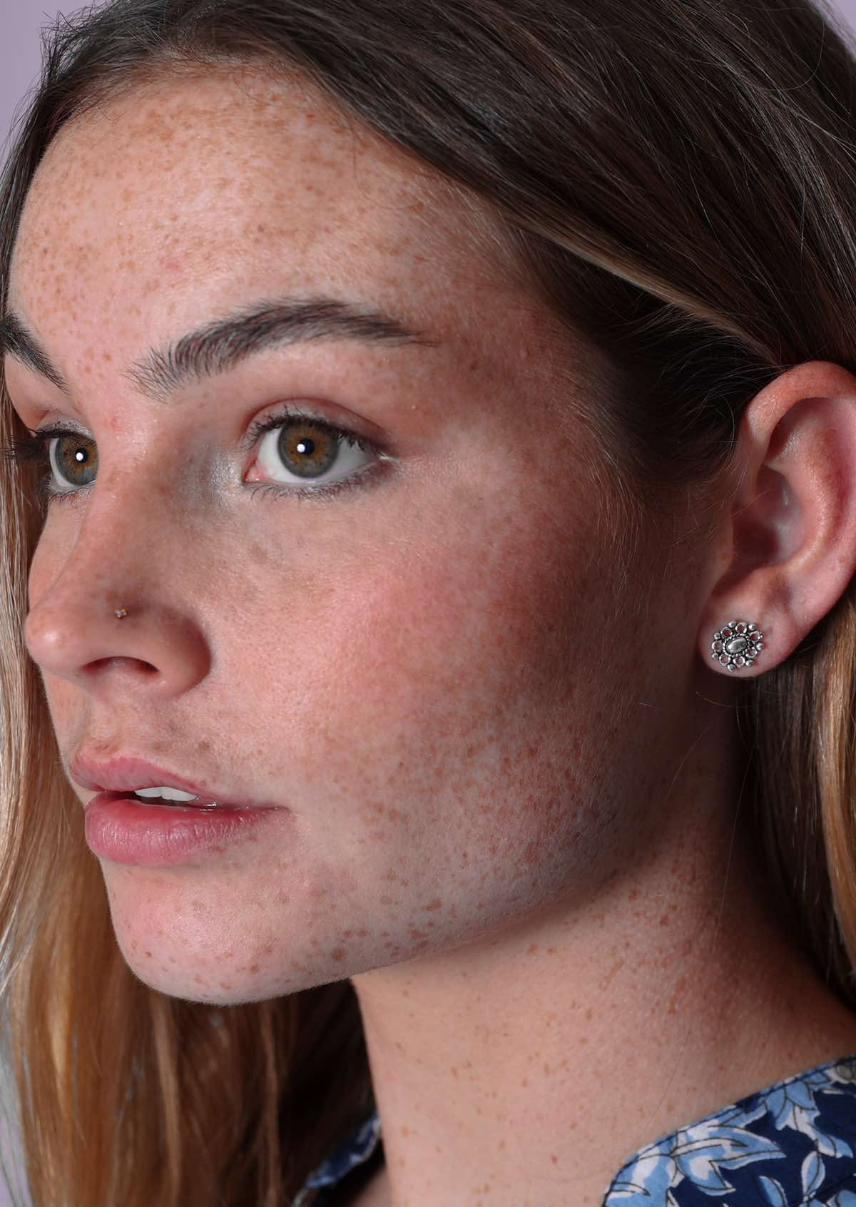 Model wears Gilded Silver Stud earrings with oval shape and silver beads and circles surrounding