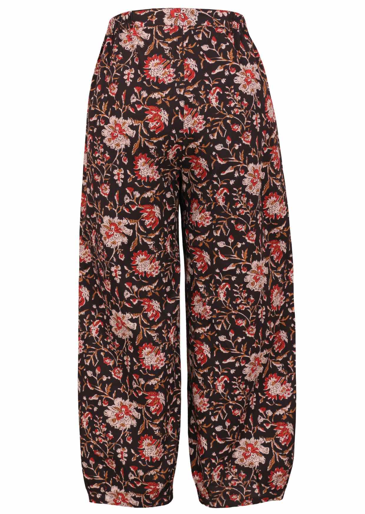 Black based traditional Indian floral print cotton pants on a white background.