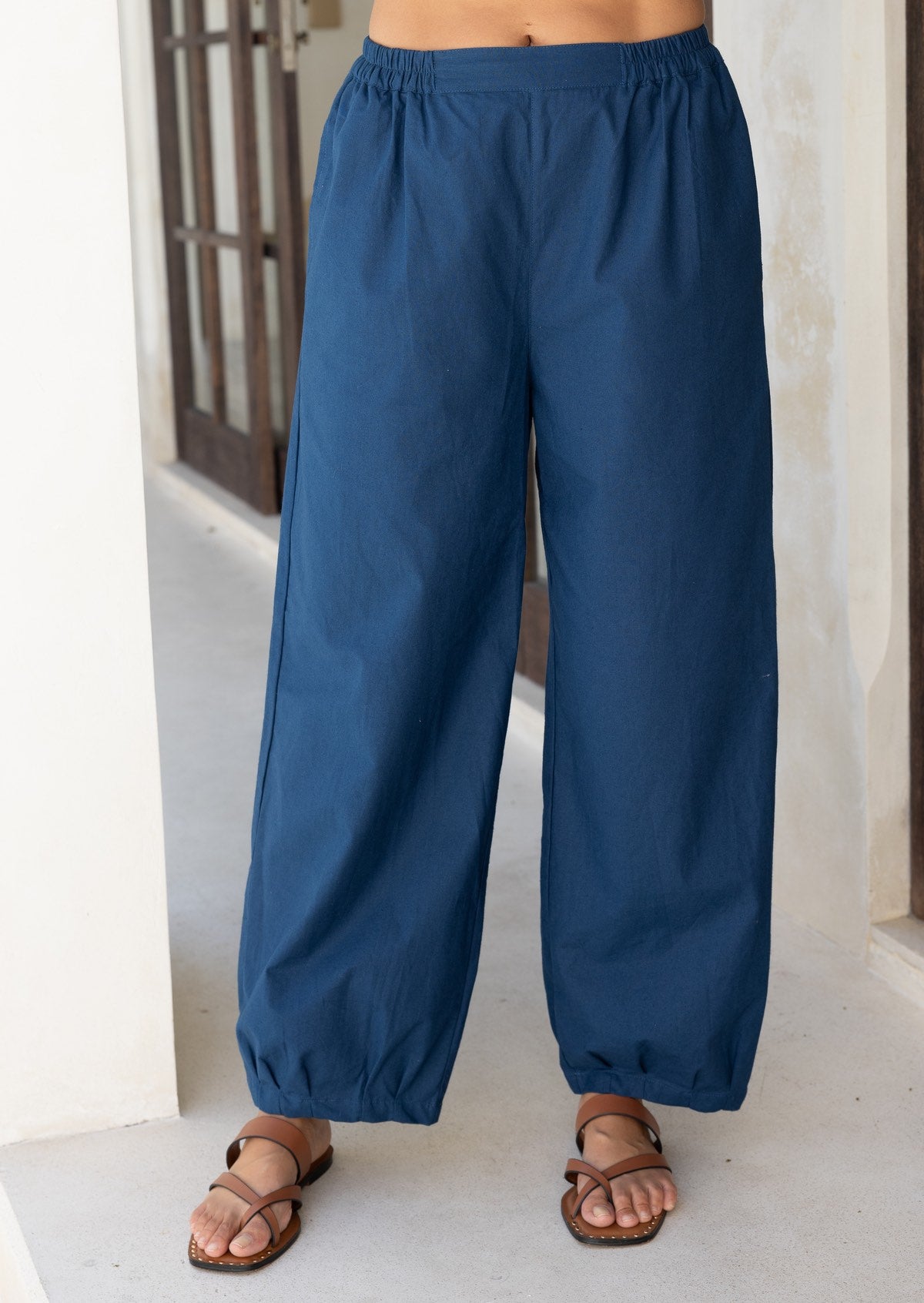 Close up of blue cotton pants showing the elastic in the sides of the waistband