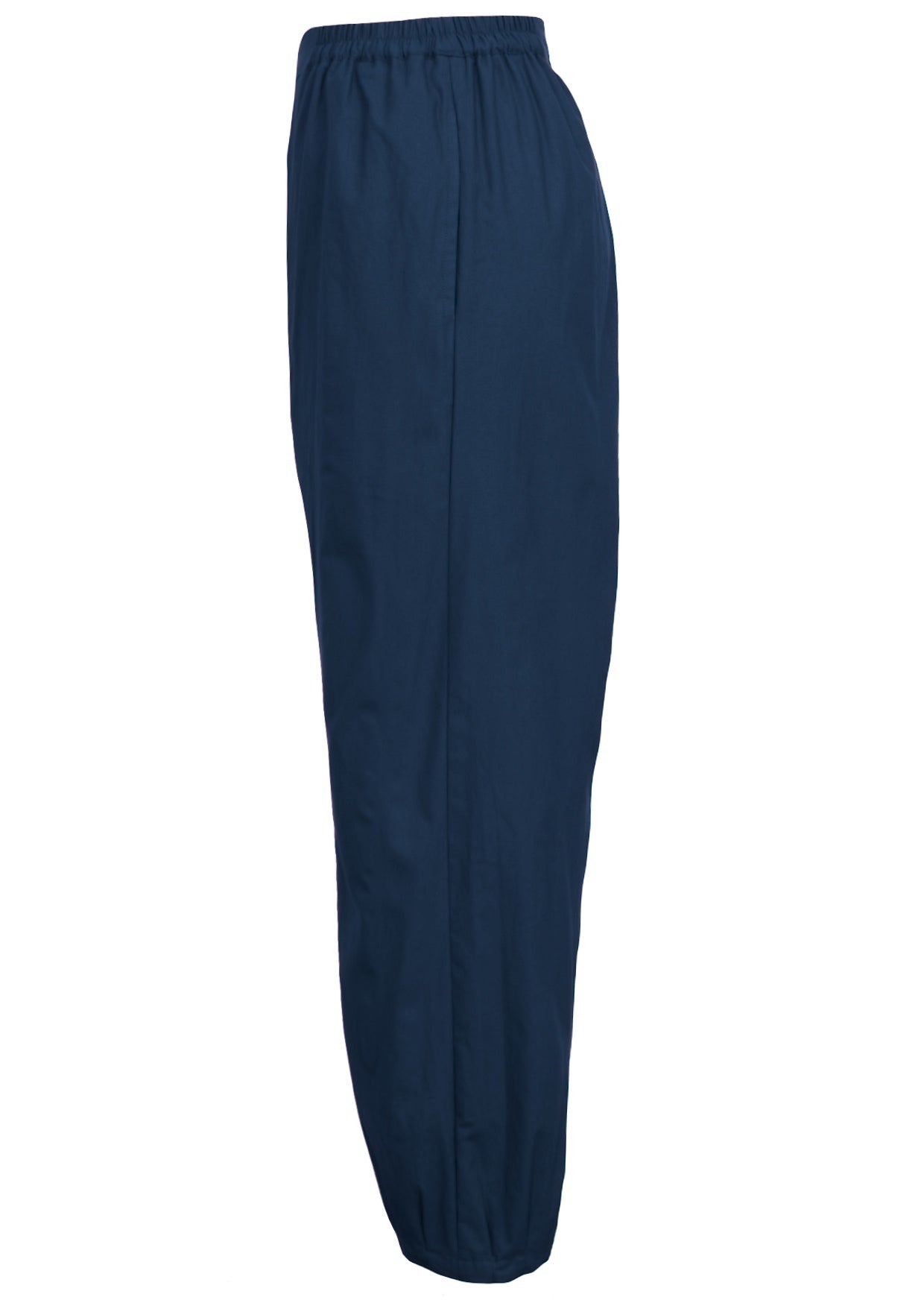 Side view of boho cotton pants with pockets and tapered, pleated ankles.