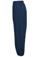 Side view of boho cotton pants with pockets and tapered, pleated ankles.