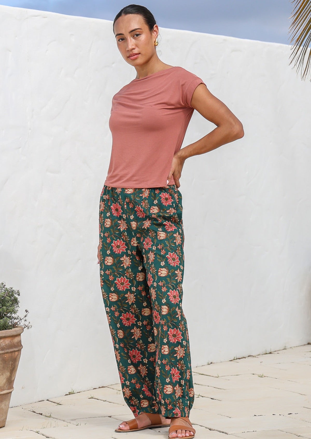Model pairs wide leg, printed cotton pants with dusty rose rayon top.