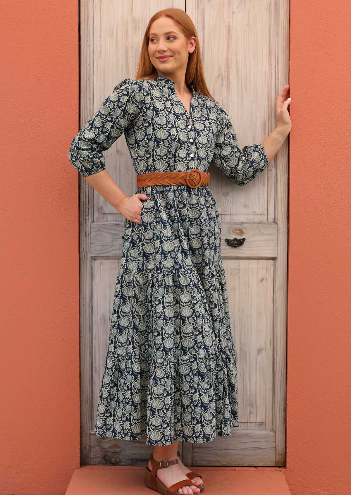 Model wears 100% cotton dress styled with a belt at the waist and sandals.