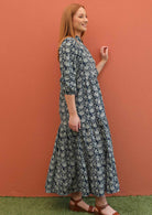 Model shows the side profile of her 100% cotton maxi dress.