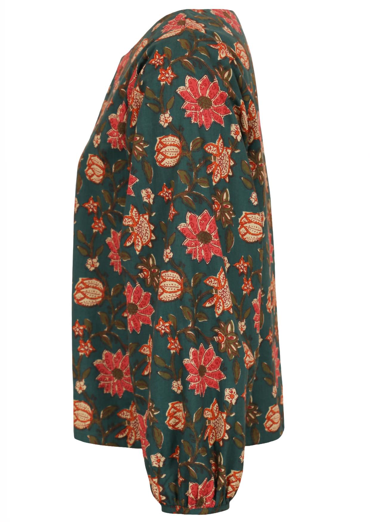 Side view of 100% cotton bishop sleeves top in bright floral print on deep green base.