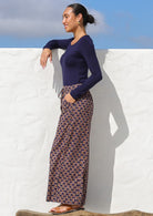 Model standing sideways wearing 100% cotton wide leg pants with a long sleeve stretch navy blue top.