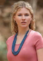 Denim blue wooden beads on four strands