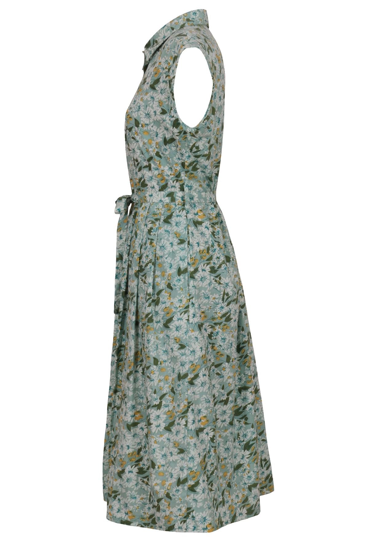 Side view of sage green based floral print cotton dress with pockets.