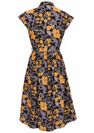 Black based floral cotton dress with cap sleeves, collar, small gathers in the centre back and waist tie