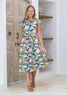 Woman wearing a pink, green, blue, mustard spotty print cotton midi day dress | Katie Dress Sweet Spot