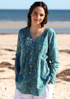100% cotton lightweight, long sleeve top with small pleats at the chest and A line flare at the base.