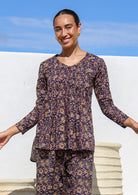 100% Cotton, button through long sleeve top with V neck and small pleats at the central front leading to flared base.