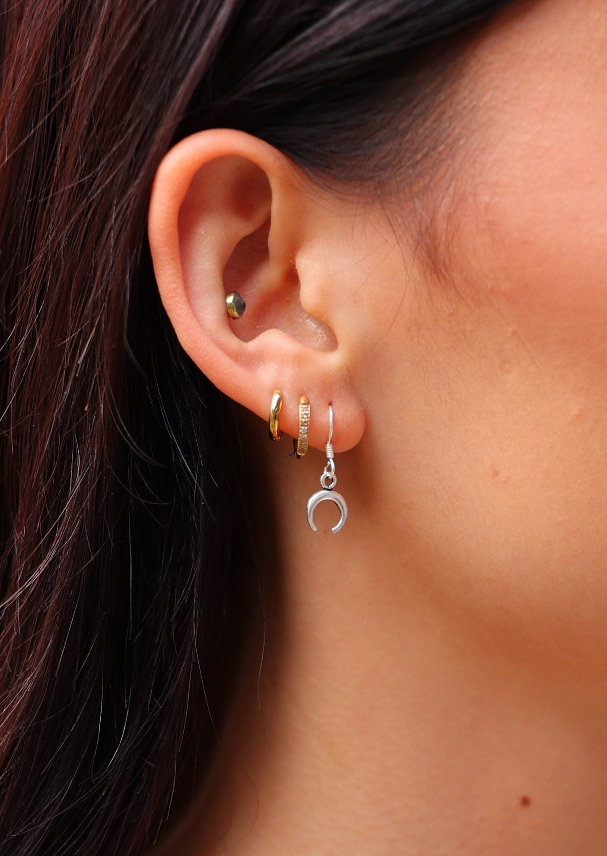 Close up of little sterling silver crescent  moon hook earring