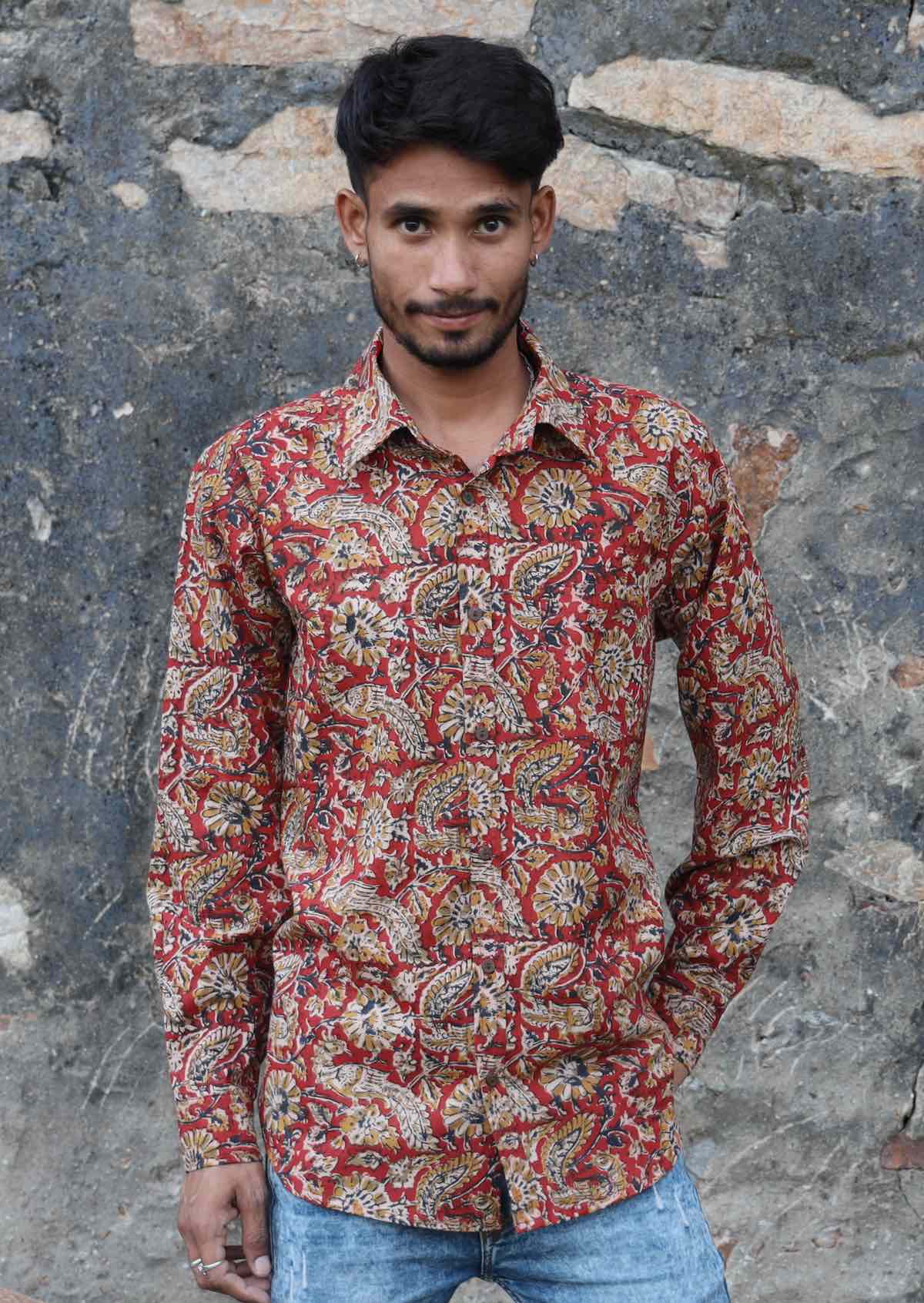 Man wears cotton long sleeve collared shirt with coconut buttons and one breast pocket