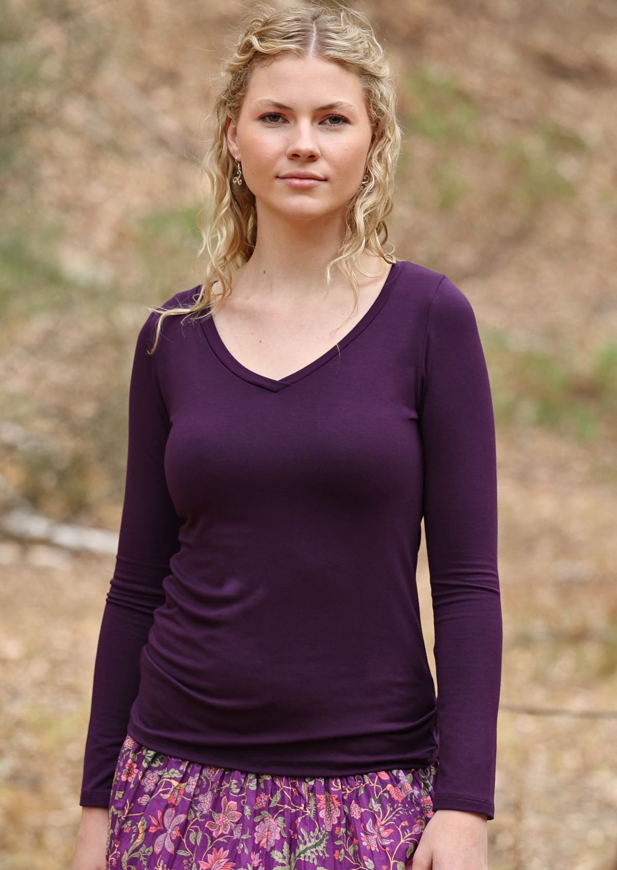 woman wearing long sleeve purple top with v neck
