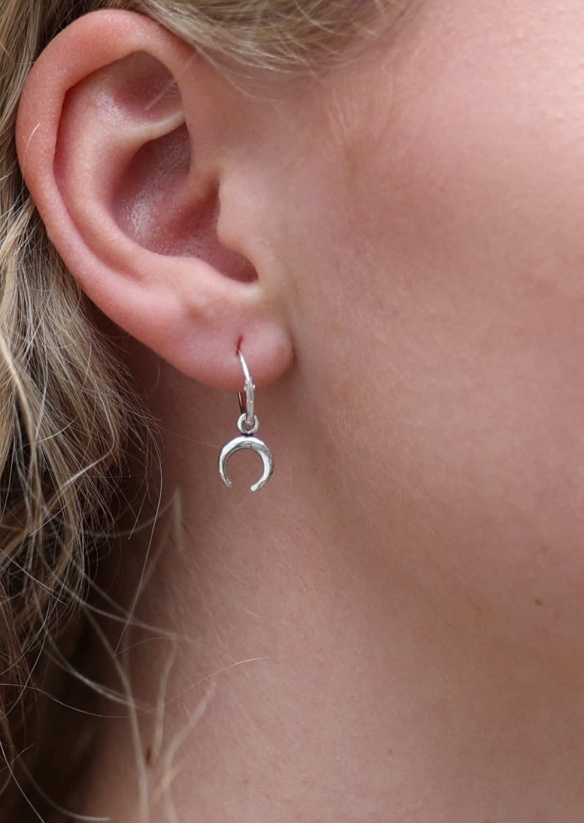 Crescent moon hangs from silver sleeper