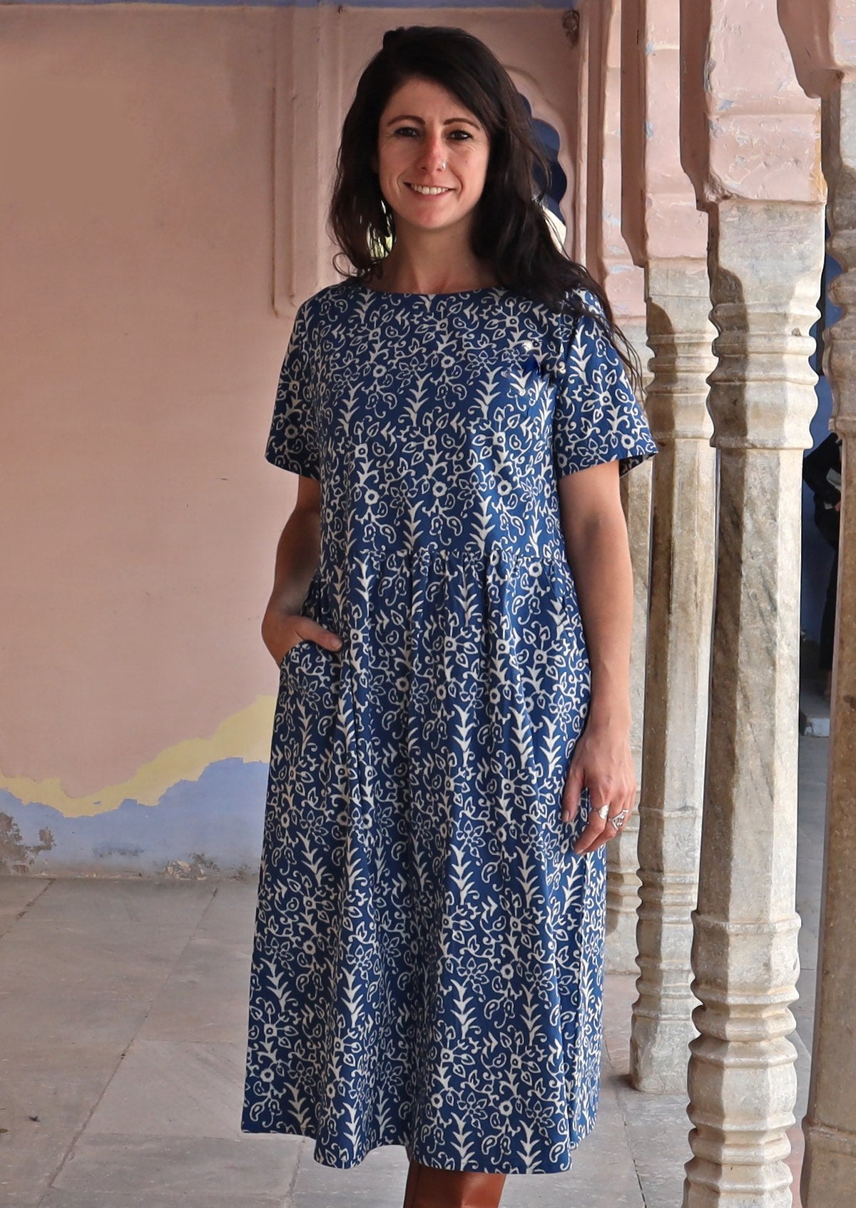Woman with one hand in pocket wearing 100% cotton blue and off white Maddison dress