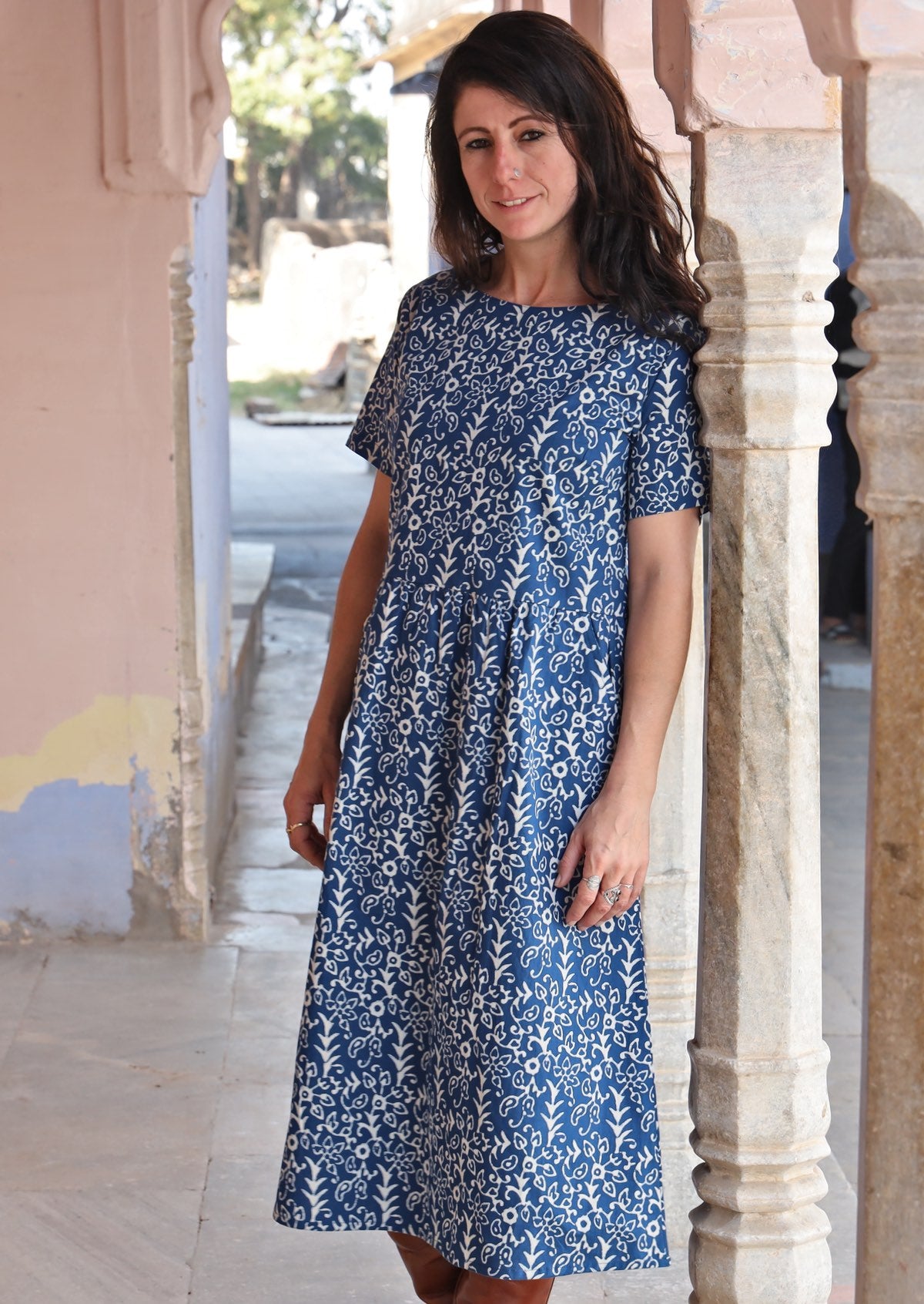 Woman stands wearing 100% cotton blue and off white dress maxi dress