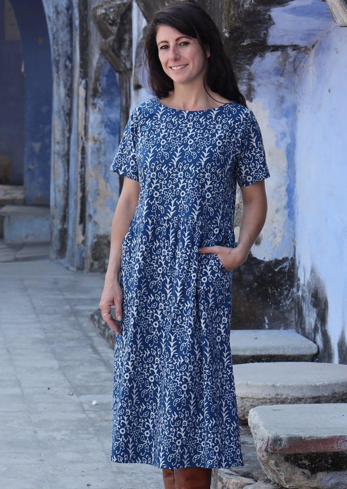 Woman with one hand in pocket wearing 100% cotton blue and off white Maddison dress