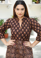 Woman wears two floral print maxi dress with mandarin collar, buttoned bodice and 3/4 sleeves.