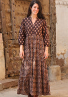 Model wearing a 100% cotton 3 tiered maxi dress with 3/4 sleeves, buttoned bodice and V neckline.