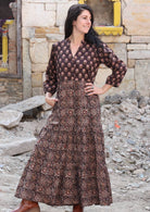 Model posing in a beautiful floral printed  cotton dress with 3/4 sleeves, mandarin collar and pockets.