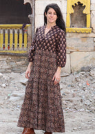 Model wears a Indian inspired cotton maxi dress in earthy tones with V neckline, 3/4 sleeves and pockets.
